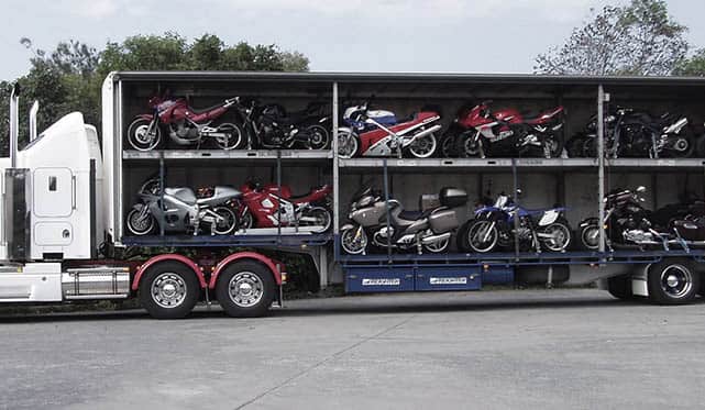 Vehicle transport via open carriers